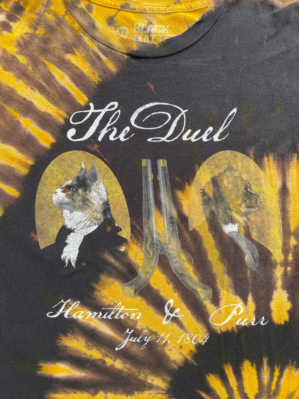 The Duel: Hamilton & Purr Black and Yellow Spiral Short Sleeve Bleached Dye T-Shirt | Men's XL Cat Pun Shirt