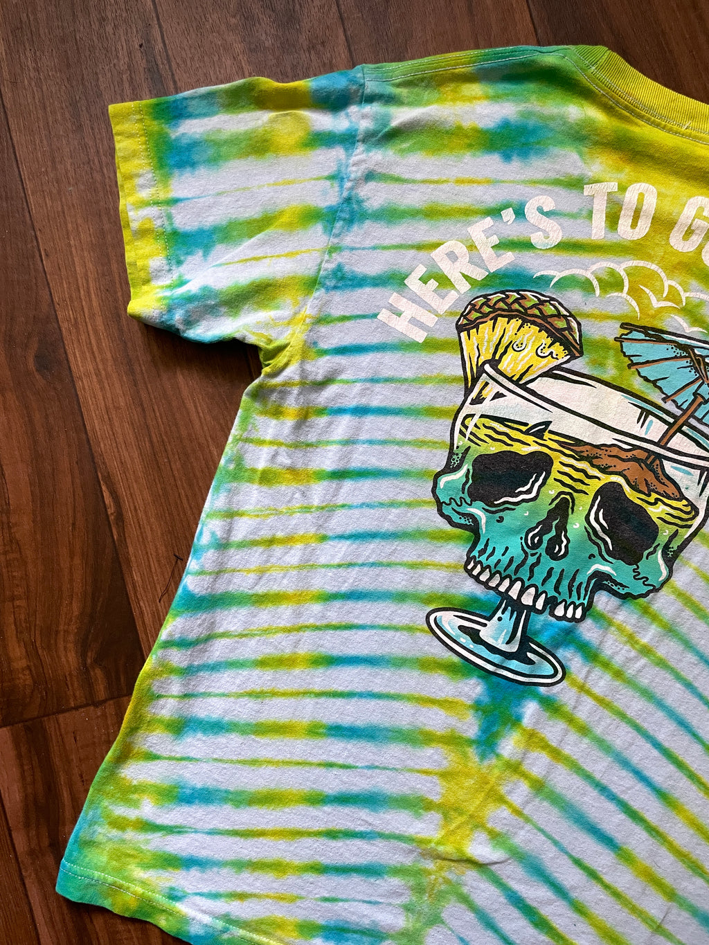 Medium Here's to Good Times Beach Skull Handmade Tie Dye Short Sleeve T-Shirt | One-Of-a-Kind Upcycled Blue and Green Pleated Tie Dye Top