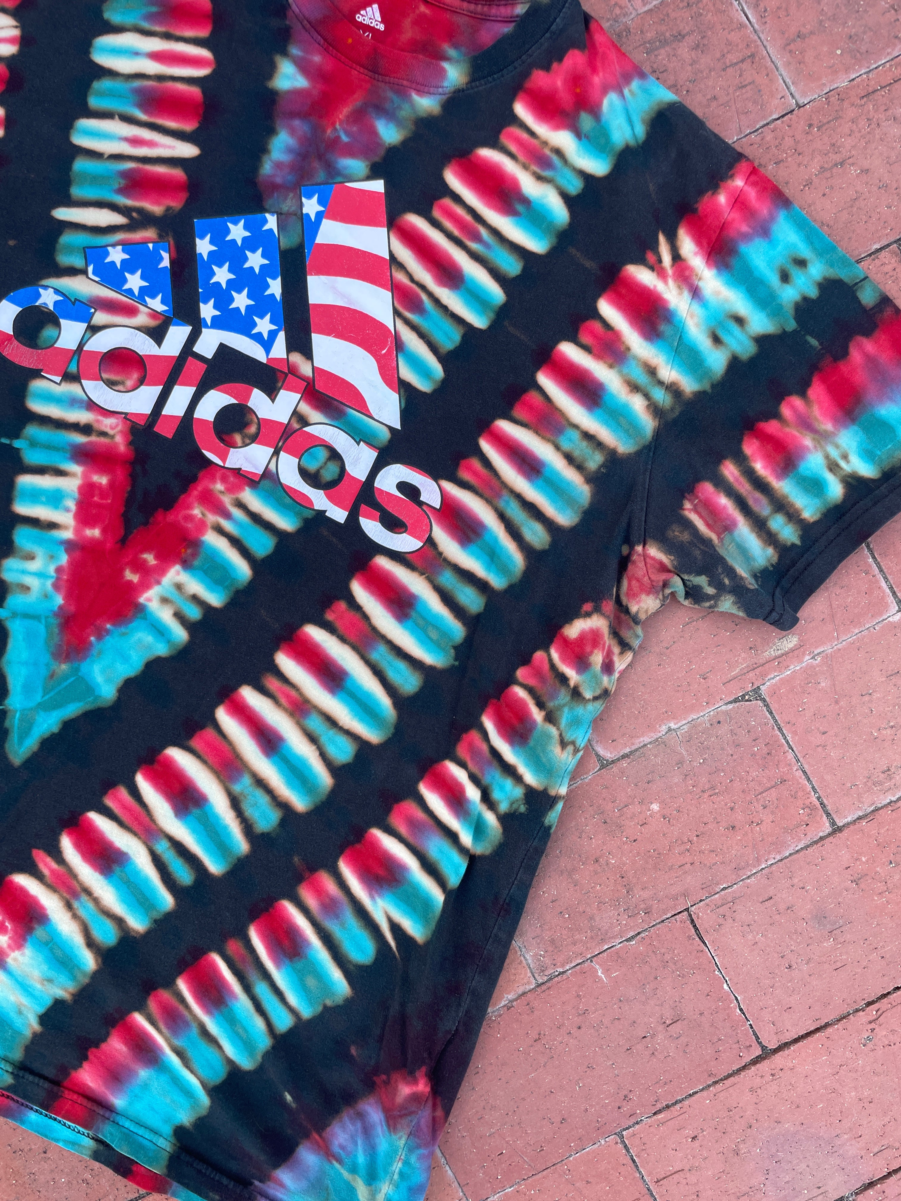 XL Men's adidas American Flag Handmade Reverse Tie Dye Short Sleeve T-Shirt | One-Of-a-Kind Upcycled Black, Red, White, and Blue V-Pleated Top
