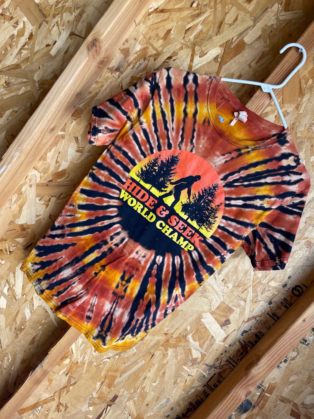 Small Men’s Big Foot Hide & Seek World Champ Handmade Tie Dye T-Shirt | Black, Brown, and Orange Pleated Tie Dye Short Sleeve