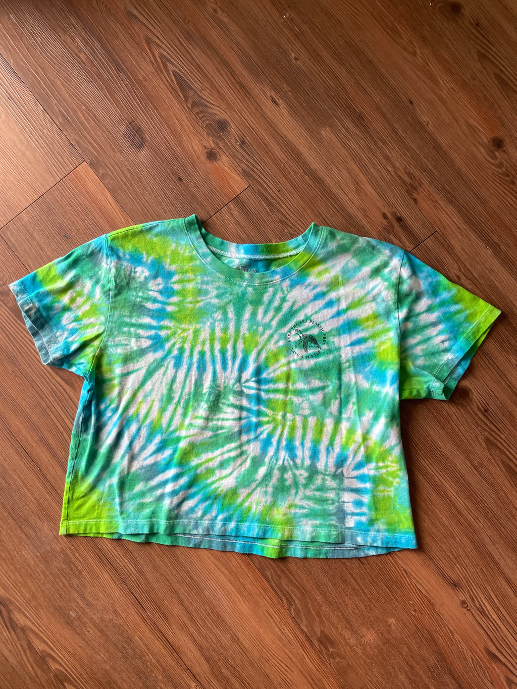 LARGE Women’s/SMALL Men's Keep the Sea Plastic Free Tie Dye Crop Top | Shades of Green and Blue Pleated Tie Dye Short Sleeve Top