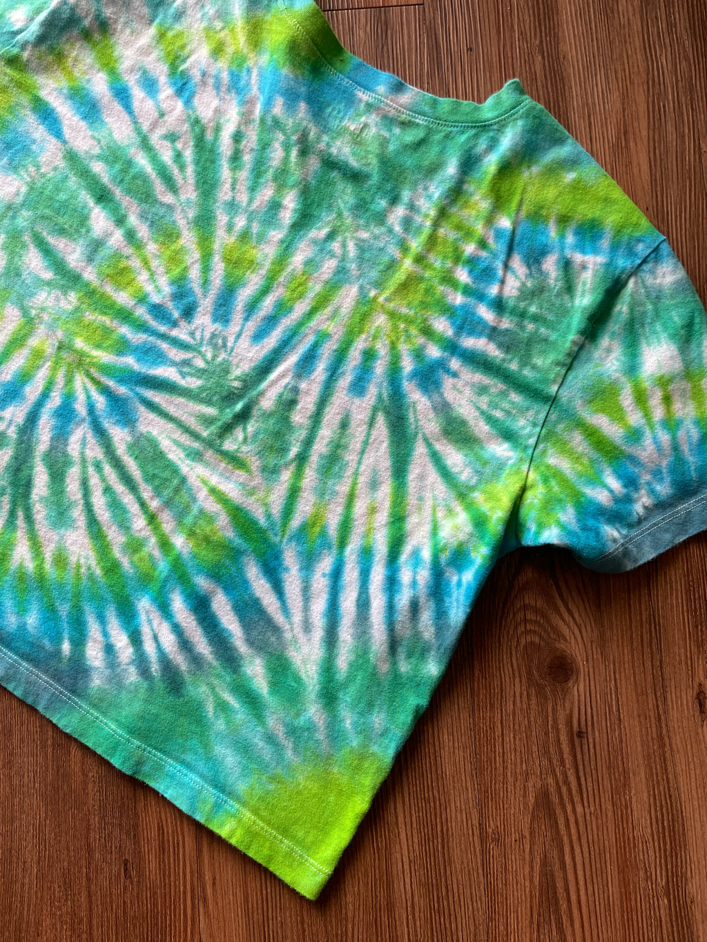 LARGE Women’s/SMALL Men's Keep the Sea Plastic Free Tie Dye Crop Top | Shades of Green and Blue Pleated Tie Dye Short Sleeve Top